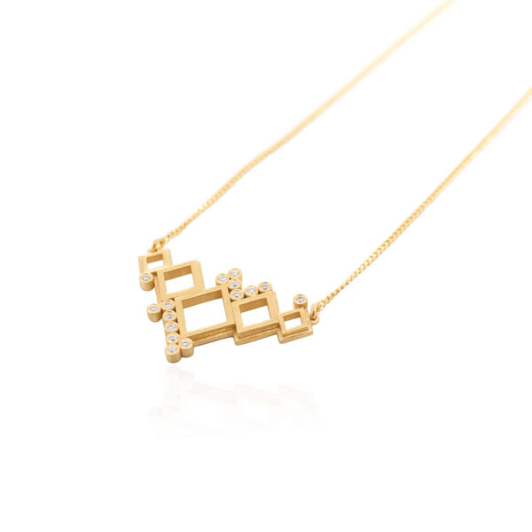 Angled view of the Napi necklace in 18K yellow gold, featuring open geometric shapes in different sizes with white diamond details on a fine gold chain.