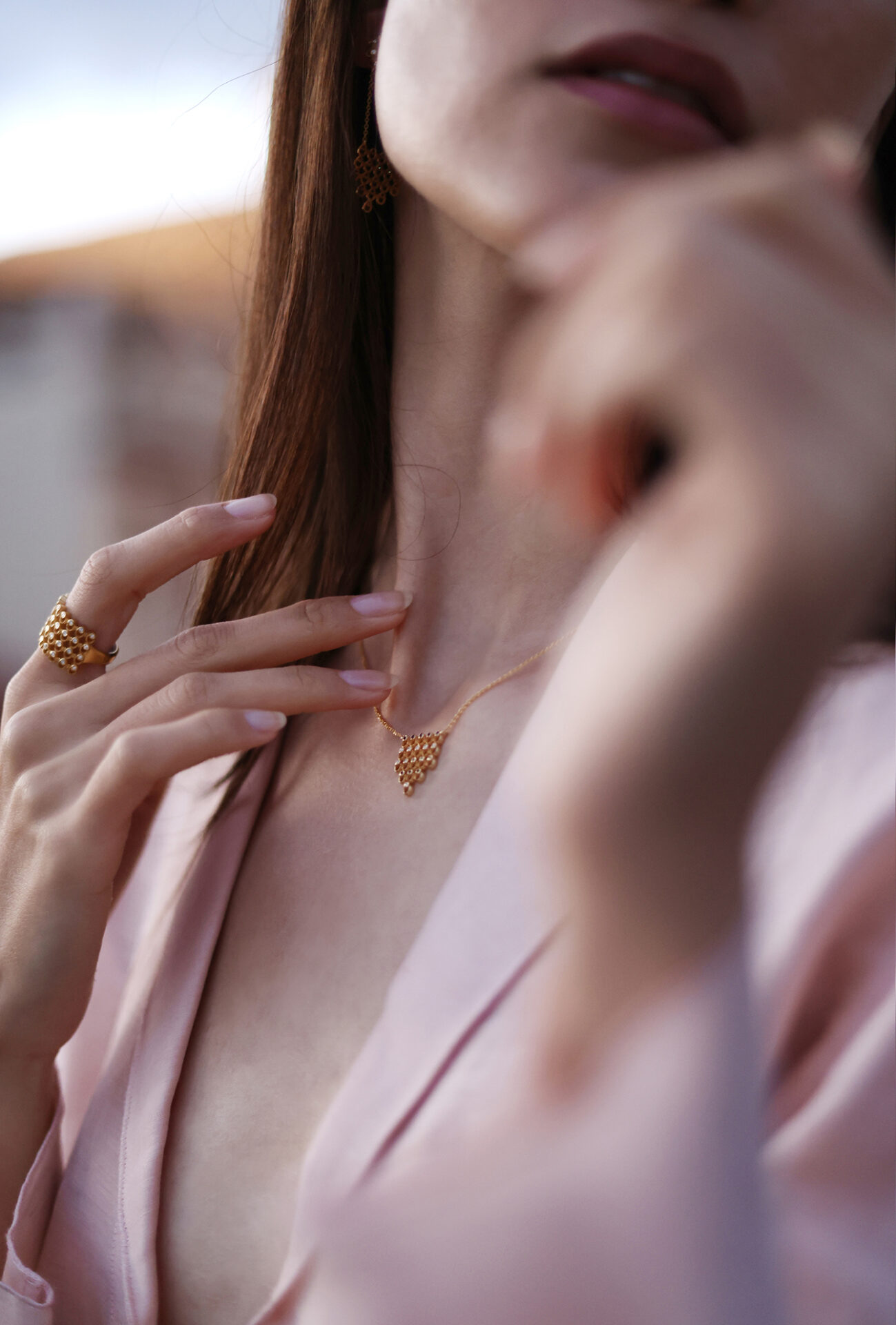 Molyvos Lines diamond ring in 18k recycled gold worn on hand, paired with matching gold pendant in soft natural light.
