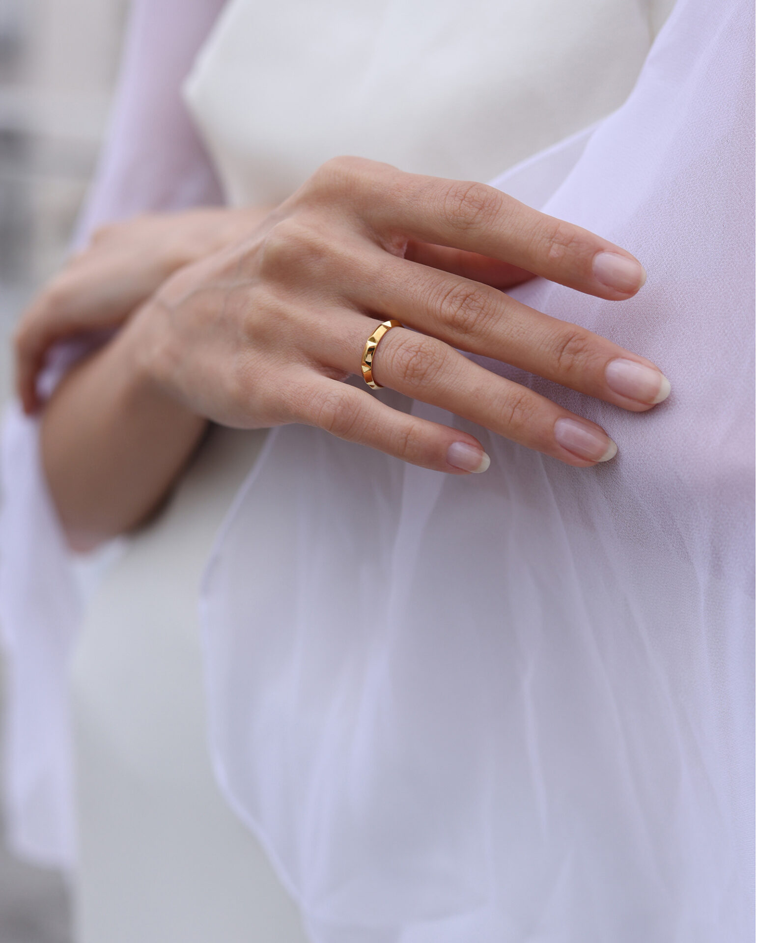 Together Bridal faceted gold wedding band – Elsa Mouzaki Bride wearing a faceted gold wedding band from the Together Bridal collection