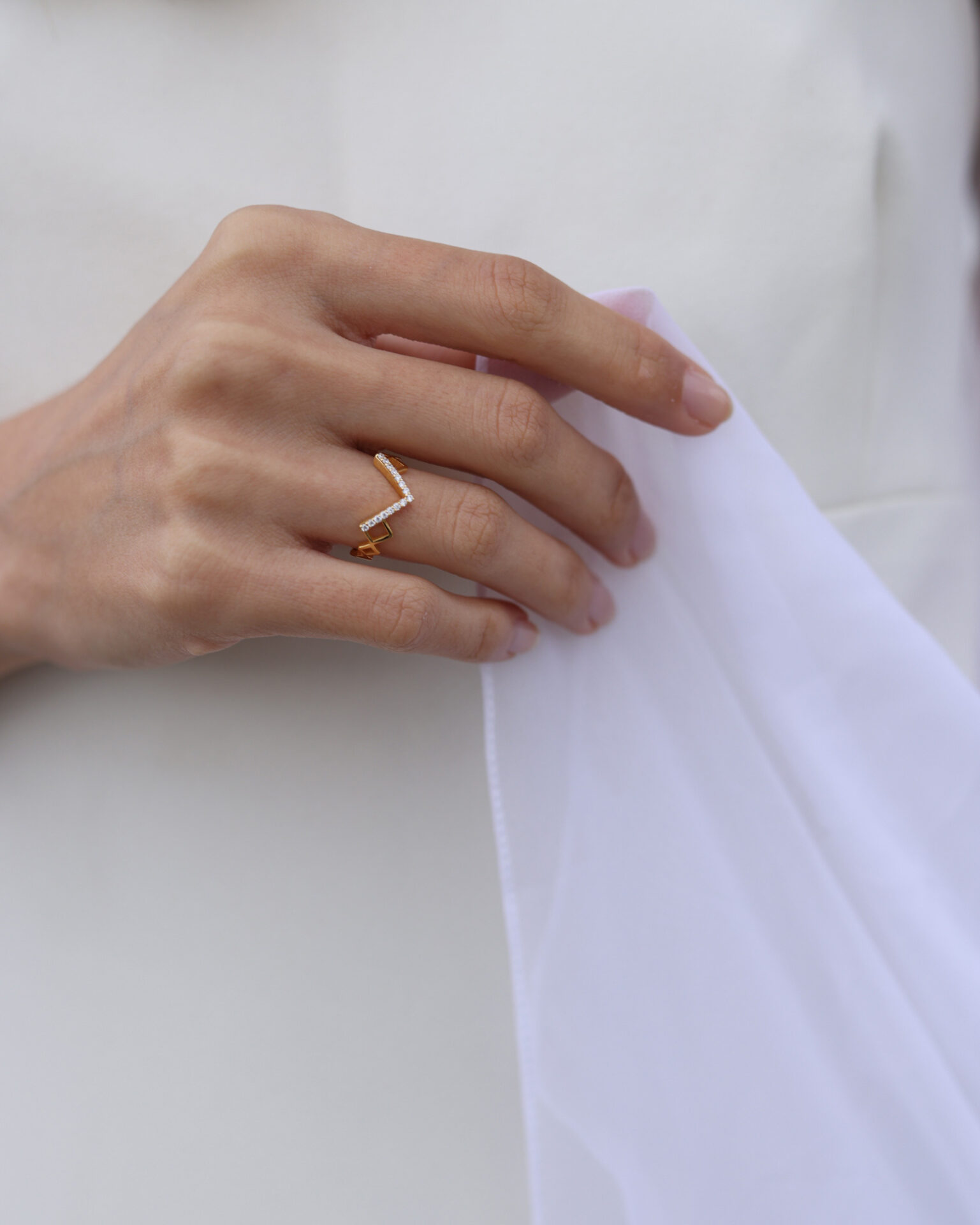 Bride wearing a geometric 18k gold and diamond ring from the Together Bridal collection